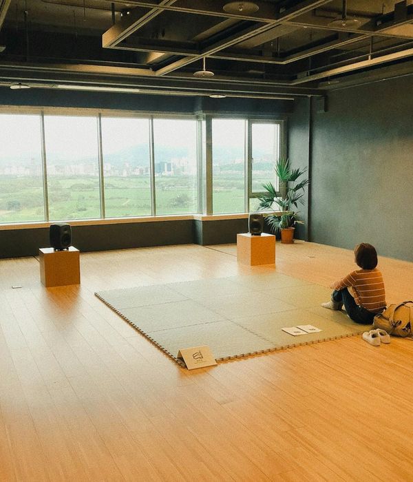 Person meditating in a quiet, minimalist space.